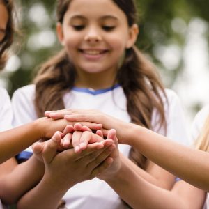 smiley-kids-putting-their-hands-each-other