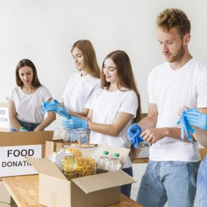 volunteers-with-gloves-preparing-food-donation